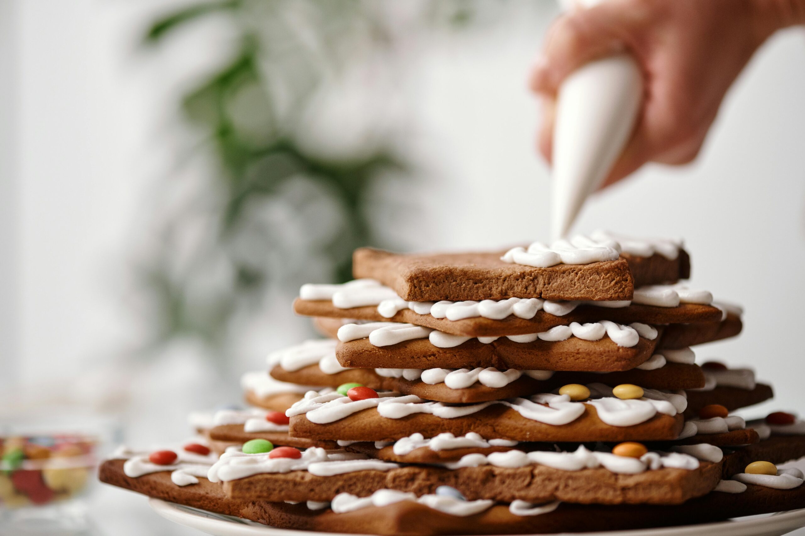 A stack of gingerbread cookies with icing, perfect for Christmas celebrations.